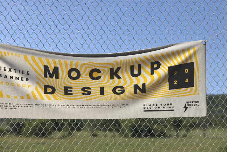 Wind-permeable mesh banner fixed to fencing